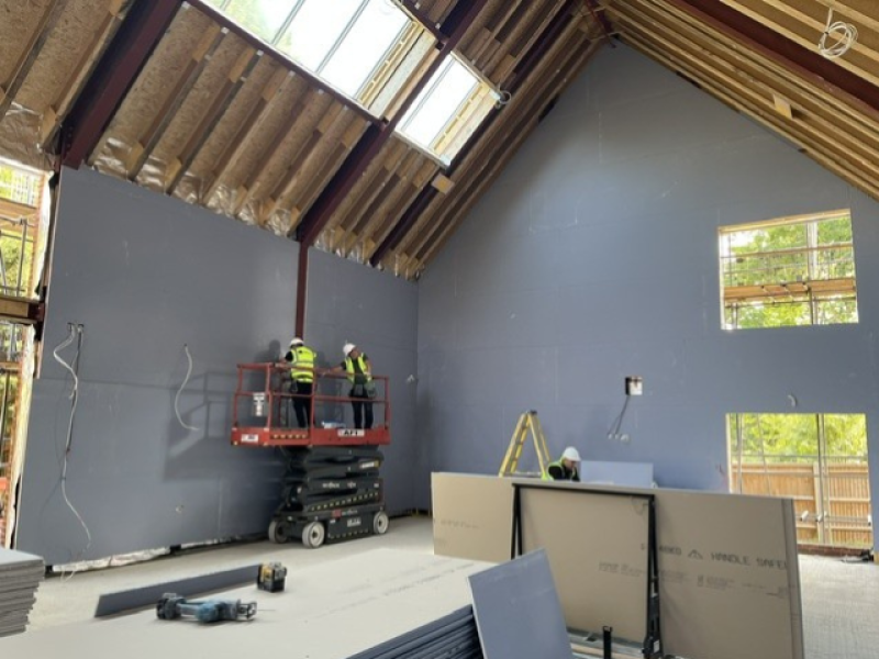 Wall boarding being screwed in place